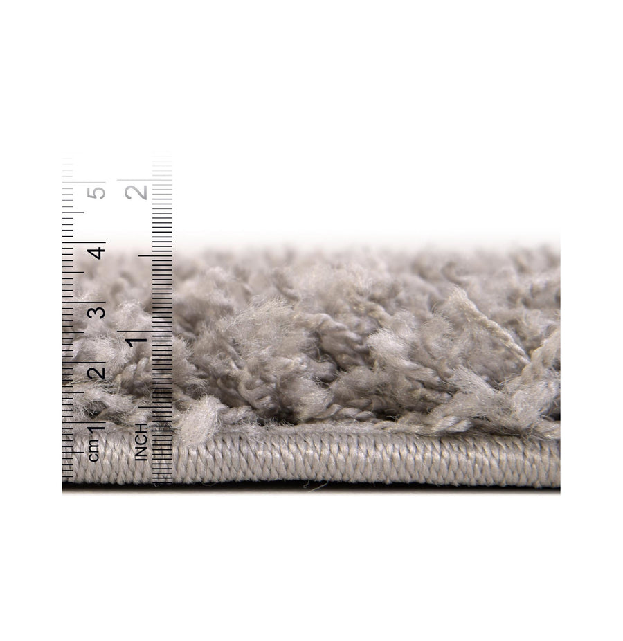 Pile depth | the pile from the side against an inch and centimeter ruler