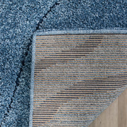 Folded corner | one corner turned back on a wood floor to show the woven backing
