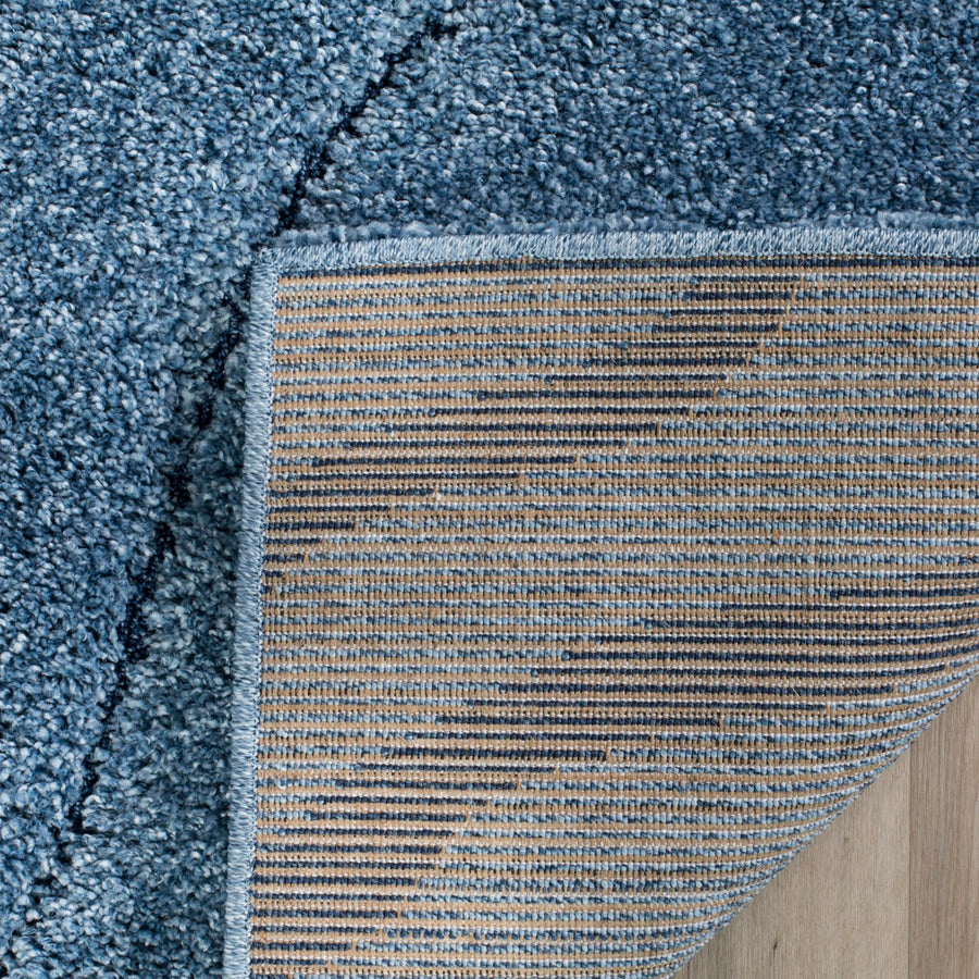 Folded corner | one corner turned back on a wood floor to show the woven backing