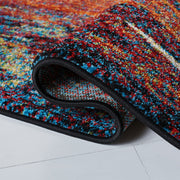 Rolled edge | the rug curled back on a white floor to show the backing