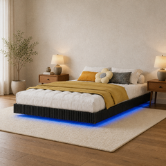 Room 1 angle | Three-quarter view of the fluted bed, bedding, two nightstands, and blue under-bed light