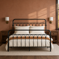 Clay room | Front view of the bed against a clay wall with brass sconces