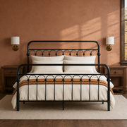 Clay room | Front view of the bed against a clay wall with brass sconces