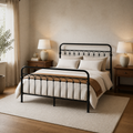Three quarter | Black metal bed viewed from the foot corner in a warm bedroom