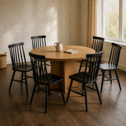 In a room | the set beside a round table in a warm plaster dining room, low afternoon light