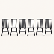 Front | all six black Windsor dining chairs centered on paper, seven-spindle backs and H-stretchers visible
