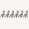 Studio | the chairs at a true three-quarter angle, spindle-back depth and the H-stretcher both reading