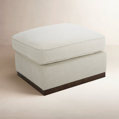 Upholstered Rectangular Ottoman with Walnut Finish Plinth Base