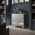 Blue-gray library | silver mirrored cabinet in cool late-day light