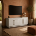 In a terracotta media room | Alder White TV stand beneath a wall-mounted TV with an arched garden doorway at left