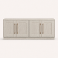 Front | straight-on studio view of the Alder White TV stand with four recessed-panel doors and four antique-brass pulls