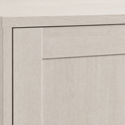Material close-up | pale Alder White surface with subtle straight wood grain and a crisp recessed-panel edge