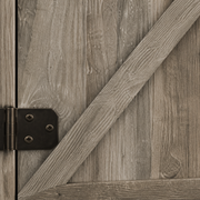 Wood texture close-up | Gray-washed wood-grain barn door, raised X brace and dark hinge