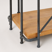 Construction close-up | fir shelf corner, cast pipe collar, rounded rail, foot, and bolted rear brace