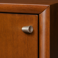 Detail | small round chrome pull on the sliding door beside the mahogany cherry wood frame