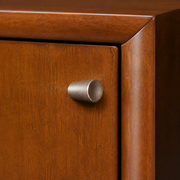 Detail | small round chrome pull on the sliding door beside the mahogany cherry wood frame