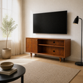 Angle | three-quarter room view of mahogany cherry TV stand showing the right side panel, open shelves, cable ports, and tapered legs