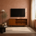 In a room | mahogany cherry TV stand against a terracotta wall beneath a blank screen, with an olive plant, lamp, and plain rug