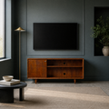 In a room | mahogany cherry TV stand against a deep blue-green paneled wall beneath a blank screen, with a brass lamp and plain rug
