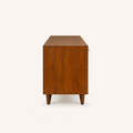 Studio | right side profile of the mahogany cherry TV stand showing the full depth, solid side panel, top, and tapered legs