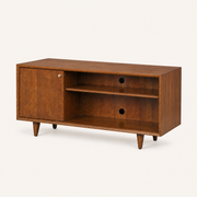 Studio | three-quarter mahogany cherry TV stand showing its right side panel, top, open shelves, cable ports, and tapered legs