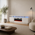 In a room | warm-white living room with the high-gloss white fireplace TV stand, blue-lit media bay, chrome posts, plant, chair and coffee table
