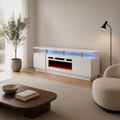 Angle | warm-white living room three-quarter view of the high-gloss white fireplace TV stand with window, plant, chair and coffee table