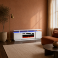 In a room | terracotta living room with the high-gloss white fireplace TV stand, blue-lit bay, rust chair, olive tree and window