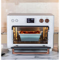 Kitchen | The oven positioned on a kitchen counter beside a cookbook and fresh herbs in a vase