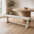 In a room | distressed-ivory pine dining bench along one side of a round pale-oak table, window at left; table is styling only