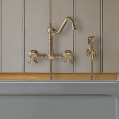 Wall Mount Kitchen Faucet with Swivel Spout and Side Spray in Antique Brass