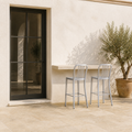 Scale | both stools beside a full-height doorway on the terrace, true size reference
