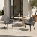 Scale | two gray open-back wicker dining armchairs beside a full-height doorway on a terrace