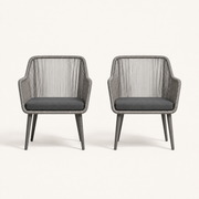 Front | two gray open-back wicker dining armchairs with single gray seat cushions on clean studio ground