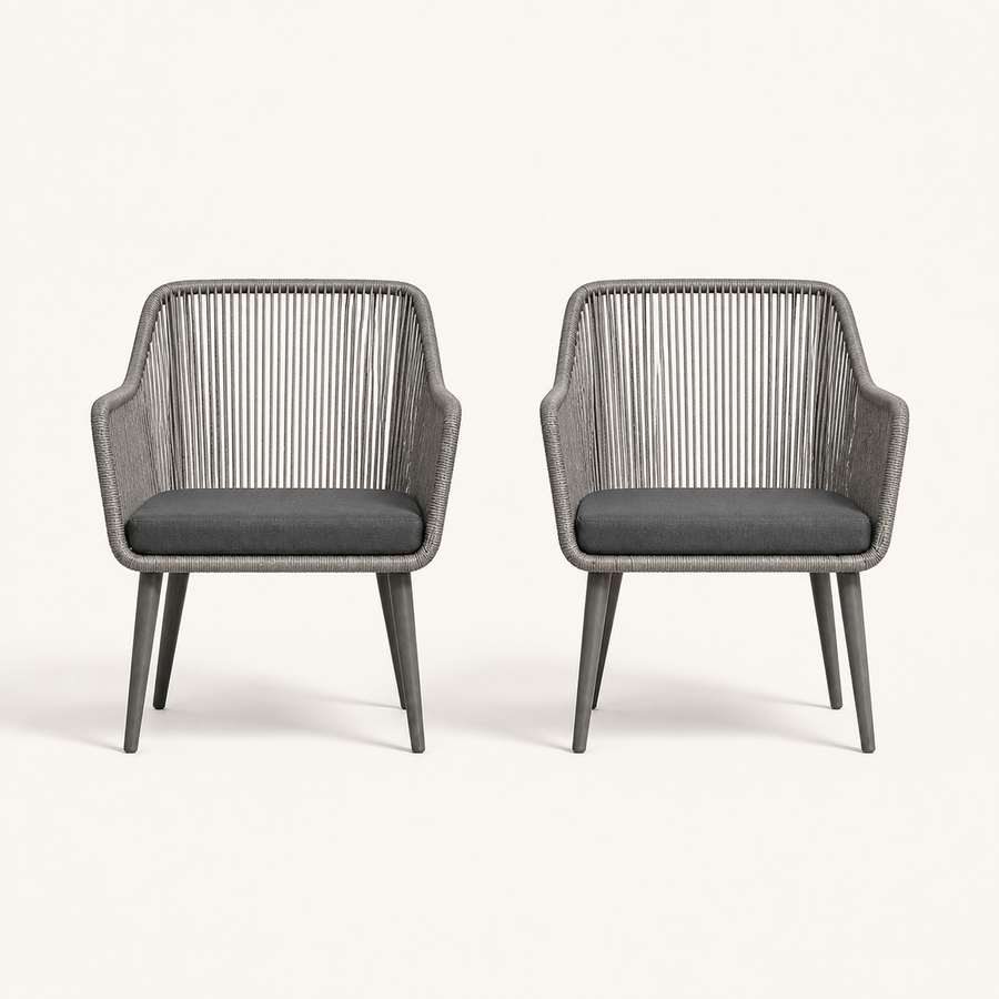 Front | two gray open-back wicker dining armchairs with single gray seat cushions on clean studio ground
