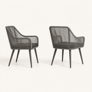 Side | two gray open-back wicker dining armchairs showing open backs, side rails, and tapered legs on clean studio ground