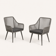 Three-quarter | two gray open-back wicker dining armchairs showing wrapped rails, open backs, and tapered legs on clean studio ground