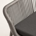 Close view | gray polyethylene-wicker rail wrap, vertical strands, and gray seat-cushion texture on one armchair