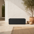 Mediterranean terrace | empty matte charcoal-black composite trough planter on pale limestone beside an olive tree