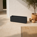 Mediterranean terrace angle | empty matte charcoal-black composite trough planter from an elevated three-quarter view