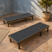 Courtyard | two flat mesh chaise lounges on terracotta tile