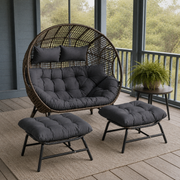 Screened porch | Complete woven egg chair set with two ottomans on a blue-gray coastal porch