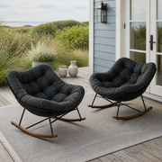 In a room | coastal porch with the two dark gray cushioned rocking chairs and their curved wood-grain runners