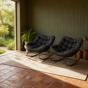 In a room | sage garden veranda with the two matching dark gray cushioned rocking chairs