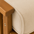 Texture | close view of the cream cushion weave, self piping, and warm brown acacia arm rail