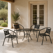 Scale | four black stacking patio armchairs beside a full-height patio doorway for scale