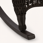 Rocker runner detail | close view of dark curved runner, squared end cap, and wrapped lower leg