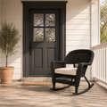 In scale | espresso resin-wicker rocking chair beside an uncropped charcoal exterior doorway