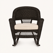Studio front | espresso resin-wicker rocking chair with pale tan seat cushion and curved rocker runners