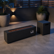 Rooftop terrace | Unlit brushed iron fire table and square tank cover on a blue-hour concrete terrace
